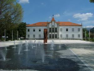 a building with a fountain in front of a building at Ares Vieira in Vieira do Minho