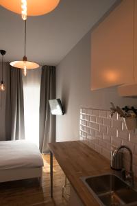 a kitchen with a sink and a bed in a room at SMILE&LOVE REPUBLIC ZAGREB CENTER in Zagreb