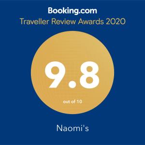 a yellow circle with the number nine and the text travelling review awards at Naomi's in Rosh Pinna