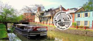a boat is docked in a canal next to houses at The Georgetown House Inn in Washington