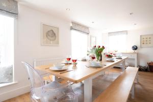 a dining room with a wooden table and chairs at Mansard House in Aldeburgh