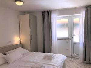 Posteľ alebo postele v izbe v ubytovaní Apartments Trlika