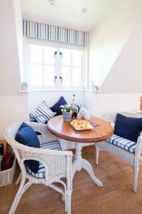 a dining room with a table and two chairs at The Bay Tree Studio in Thorpeness