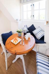 a wooden table with a plate of fruit on it in a living room at The Bay Tree Studio in Thorpeness