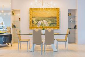 uma sala de jantar com uma mesa com cadeiras e um quadro em Apartamenty Market Square em Breslávia