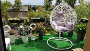 a white swing chair sitting on a green lawn at Pokoje Gościnne Zblewo in Zblewo