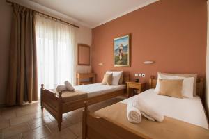 A bed or beds in a room at Atira Apartment Hotel