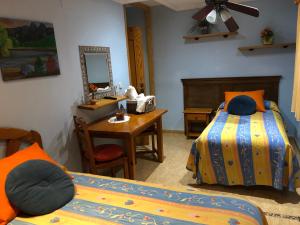 a bedroom with two beds and a desk and a mirror at Chiki in Peñíscola