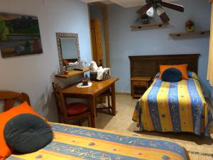 a bedroom with two beds and a desk and a mirror at Chiki in Peniscola