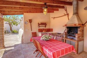 a kitchen with a table and a stove at La Font - Vallem Properties in Pollença