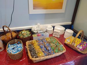 a table with baskets of candies and baskets of food at Days Inn by Wyndham Mt Pleasant-Charleston-Patriots Point in Charleston