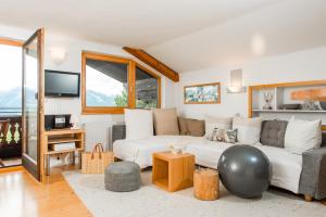 sala de estar con sofá y TV en Alpin Appartement Reinhard Tritscher, en Ramsau am Dachstein