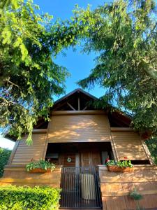 a house with potted plants on the front of it at Verde Land - Drewniany domek na wsi in Osiek Mały