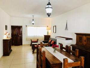 a living room with a table and chairs and a couch at Club Vergel Resort in Bernal