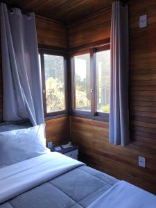 En eller flere senge i et værelse på Rancho Sossego da Serra