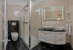 a bathroom with a toilet and a sink and a shower at Apartmani D&D Sosič in Brela +48 photos