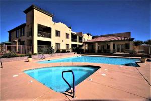 a large swimming pool in front of a house at Highlands Resort at Verde Ridge in Cottonwood