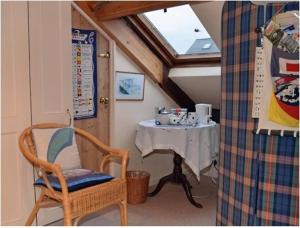 a room with a table and a chair and a table at Captains Cabin in Whitby