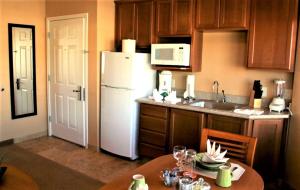 a kitchen with a table and a white refrigerator at Highlands Resort at Verde Ridge in Cottonwood