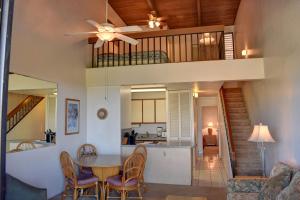 a dining room and kitchen with a table and chairs at Maui Vista 1423 in Kihei