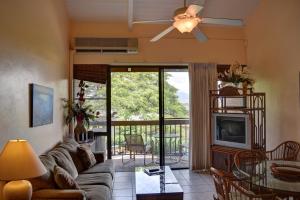 a living room with a couch and a tv at Maui Vista 2422 in Kihei