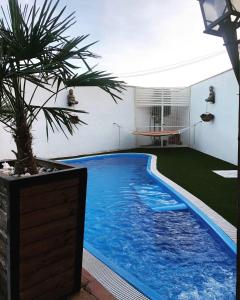 a swimming pool in the backyard of a house at Casa Rural La Sureña in Ossa de Montiel
