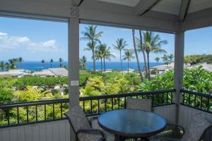 uma varanda com uma mesa e cadeiras e o oceano em Wailea Ekolu 1706 em Wailea