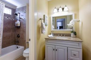 a bathroom with a sink and a toilet and a mirror at @ Marbella Lane 3BR Upper Level House in Downtown San Jose in San Jose +23 photos