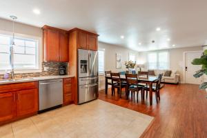 a kitchen with wooden cabinets and a dining room with a table at @ Marbella Lane 3BR Upper Level House in Downtown San Jose in San Jose