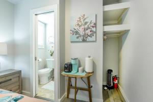 a bathroom with a toilet and a table with a toaster at @ Marbella Lane Mini Guest House in Downtown San Jose in San Jose