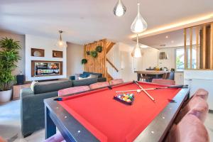 a living room with a pool table in a living room at MickeyRelax - House Spa Sauna next Disneyland Paris in Villeneuve-le-Comte