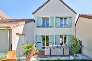 a house with blue shutters and a deck at MickeyRelax - House Spa Sauna next Disneyland Paris in Villeneuve-le-Comte