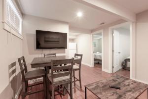 a dining room with a table and chairs and a tv at @ Marbella Lane 2BR Lower Level House in Downtown San Jose in San Jose