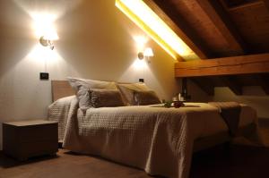 a bedroom with a bed with two lights on it at Maison Constance in Bionaz