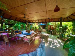 an outdoor patio with a table and chairs at OASIS by Four Twenty in Chalong