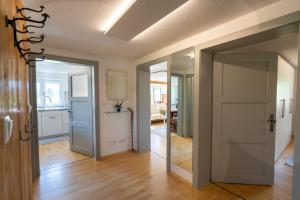 um corredor com uma porta que conduz a uma cozinha em Ferienwohnung "Florin" em Ofterschwang