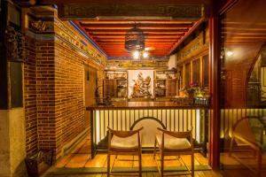 two chairs sitting at a bar in a kitchen at Xiamen Lanqin Gucuo Mansion in Xiamen