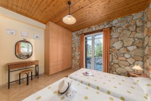 A bed or beds in a room at Trapezaki Garden Villas