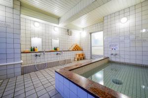 a large bathroom with a tub and a shower at Ryokan Wakamiya in Kyoto