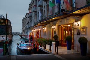 ヴェネツィアにあるバリオーニ ホテル ルナ ザ リーディング ホテルズ オブ ザ ワールドの建物の横の運河の船
