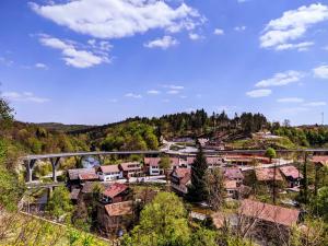 a town in the mountains with a bridge and houses at Apartments Vesna in Slunj