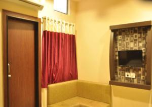 ウッジャインにあるHotel Royal Palace - 150 Meters from Mahakal Templeのバスルーム(赤いカーテンのシャワー付)