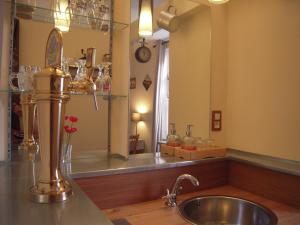 a bathroom with a sink and a large mirror at Bed&B La Ferme De L'ostrevent in Estrées