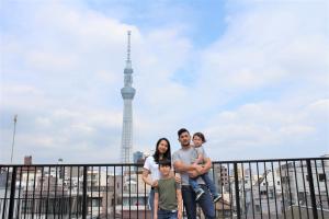 a family posing in front of the eiffel tower at plat hostel keikyu asakusa karin in Tokyo