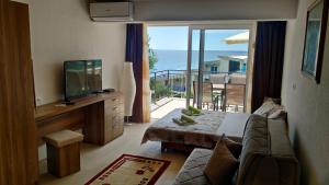 a living room with a television and a balcony at Apartments Abramovic 2 in Sutomore