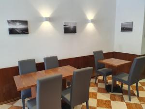 una sala da pranzo con tavoli e sedie in legno di Hotel Sole a Eraclea Mare