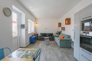 a living room with a couch and a table at SunRise Cassis in Cassis