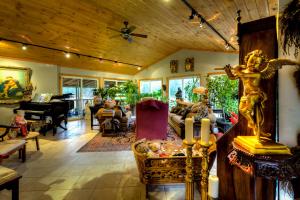 a living room with a statue of an angel on a table at Shambhala Bed and Breakfast in Buckhorn