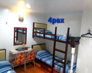 a room with two bunk beds and a mirror at AMBIANZA APARTELLE in Manila