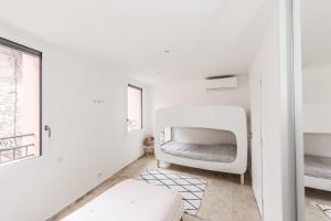a bedroom with a white bed in a white room at LOCAPPART CASSIS en Provence in Cassis